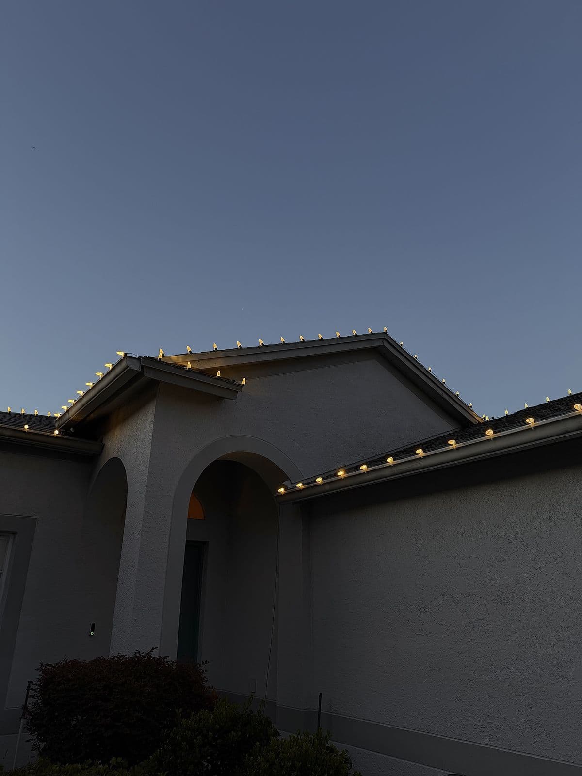 Stepped gables at dusk lined with warm white C9 bulbs